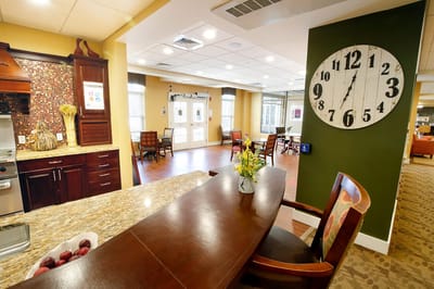 Interior view of a common area with a clock and seating