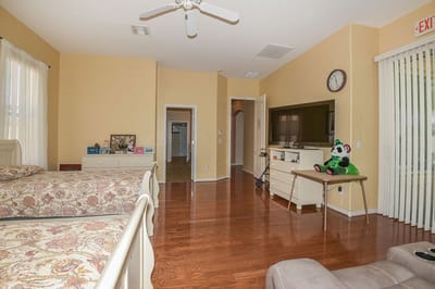 Brightly lit interior of a resident room with two beds