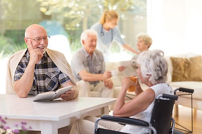 Residents enjoying a social activity in a bright common area