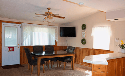 Bright common area with a dining table and exit door