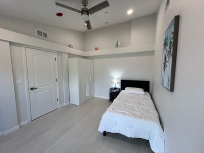 Bright, simple bedroom design with a single bed