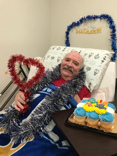 Resident celebrating a birthday with cupcakes and decorations