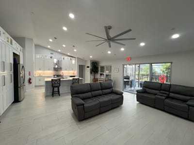 Bright common area with seating and kitchen access