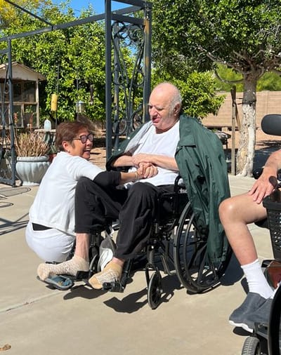 Residents enjoying a moment together outside at the facility