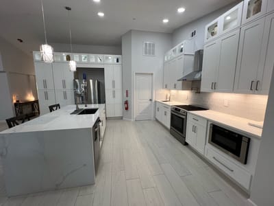 Modern kitchen with white cabinets and appliances