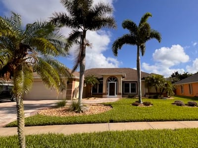 Exterior view of Villa Lea At Viera with palm trees