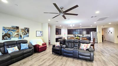 Bright common area with seating and kitchen space