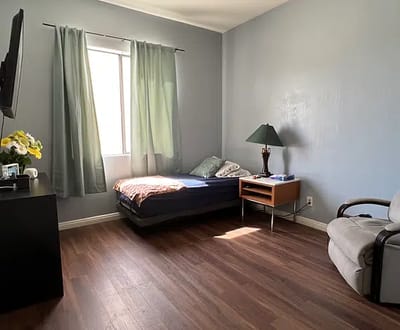 Cozy bedroom setting with a bed and chair