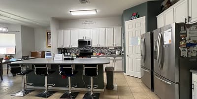 Bright kitchen area with modern appliances and seating