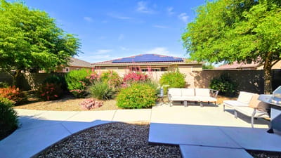 Outdoor patio area with seating and gardens