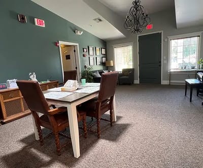 Bright common area with a table and chairs