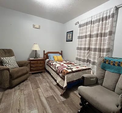 Cozy private resident room with a bed and seating