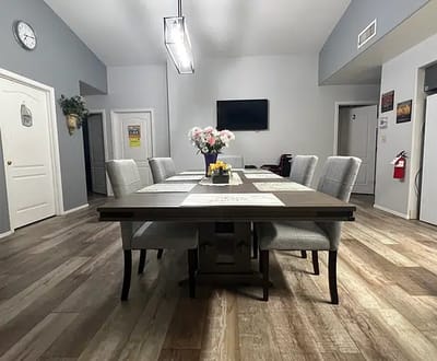 A dining room set up with a large table and chairs