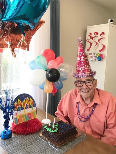 Resident celebrating a birthday with cake and decorations