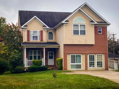 Exterior view of a residential building with a yard