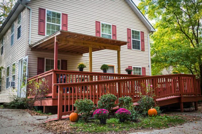 Exterior view of an assisted living facility with a porch