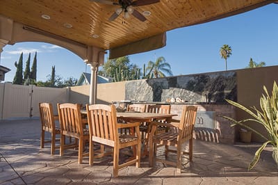 Outdoor dining area with wooden tables and chairs