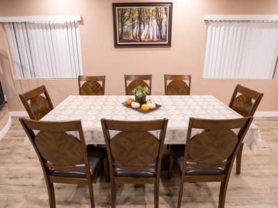 Dining area with a large wooden table and chairs