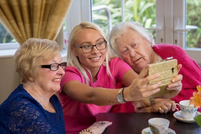 Residents and staff taking a selfie in a common area