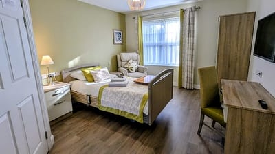 Cozy interior of a resident's room with a bed and seating