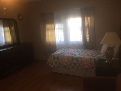 Cozy bedroom with quilt and lamp