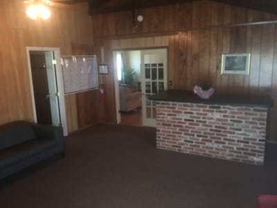 Interior view of a reception area with a brick counter