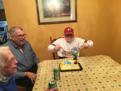 Residents celebrating with a cake and drinks.