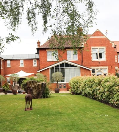 Exterior view of Lyncroft Care Home and garden area.