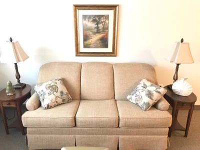 Cozy living room setup with sofa and lamps.