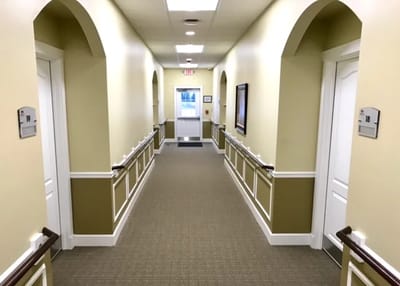Hallway with doors and signage in a facility