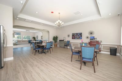 Bright and spacious dining area with tables and chairs.