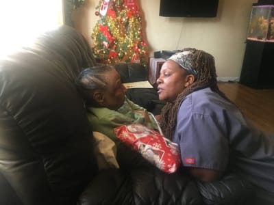 Staff member interacting with a resident during the holidays.