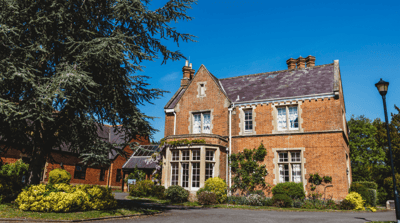 Charming red brick building with garden