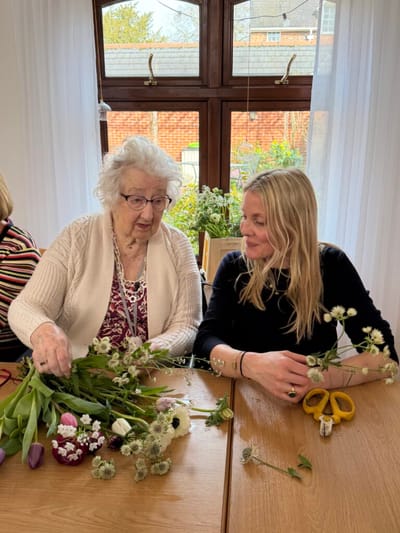 Residents engaged in a flower arranging activity