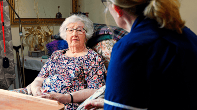 Elderly resident interacting with staff member