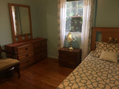 Cozy resident room with a bed and dresser