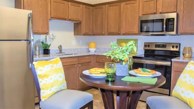 Bright kitchen area with dining table and modern appliances