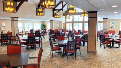 Bright dining room with red chairs and tables