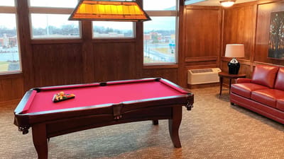 Interior game room with a billiards table