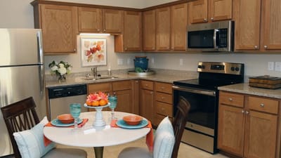 Modern kitchen with dining area in a retirement facility