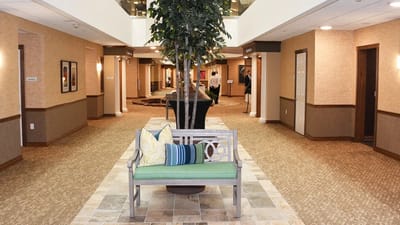 Bright interior hallway with seating and decorative plants
