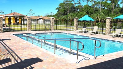 Outdoor pool area with lounge chairs and umbrellas
