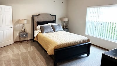 A cozy bedroom with a bed and bedside lamps