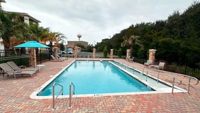Swimming pool area with lounge chairs and umbrellas