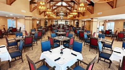 Interior view of dining area with tables set for meals