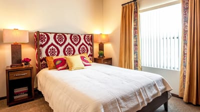 Cozy interior view of a resident room with a bed and decor