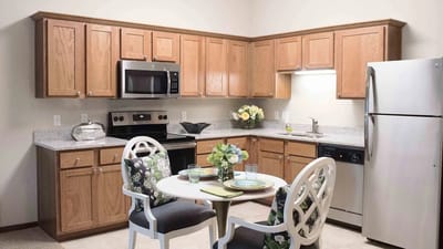 A modern kitchen space with dining table and chairs
