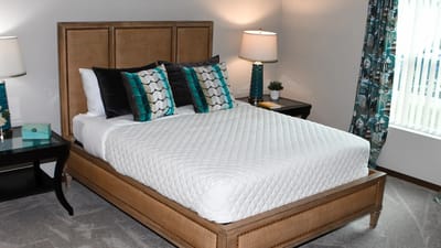 Cozy bedroom setup with a neatly made bed and decor