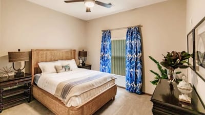 Cozy bedroom with tropical decor and large windows