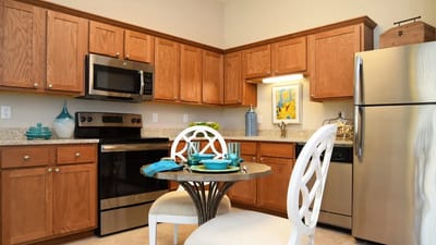 Bright kitchen area with modern appliances and dining setup